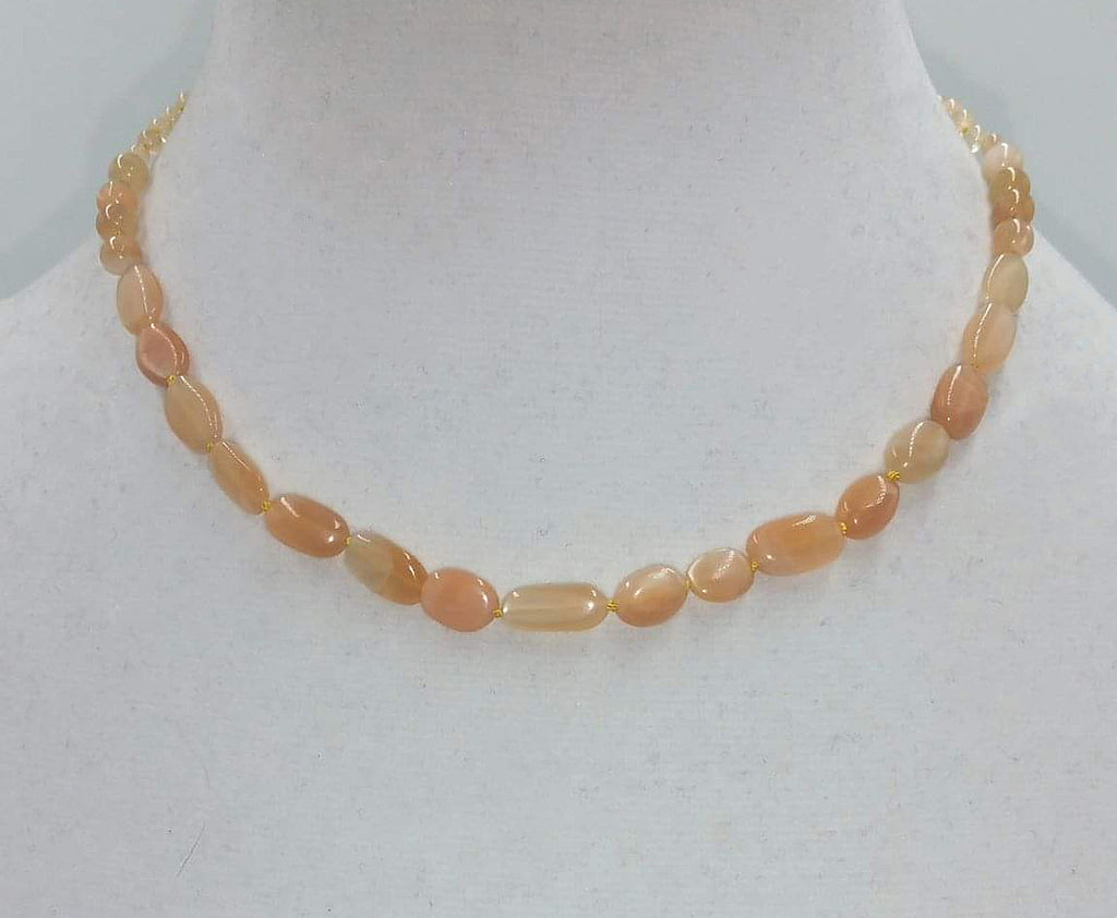 Butterscotch candy? No, it is a sunstone graduated necklace on yellow silk with 10K gold clasp. 16" length.